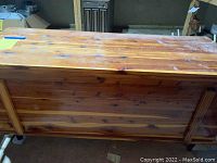 Top view of the wood chest showing wood plank construction and hinge area.