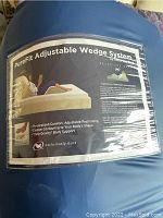 Photo of the top label on the PureFit Adjustable Wedge System packaging showing product name and image of person reclining