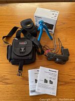 Overview of camera, box, cases, tripod, manuals and charger