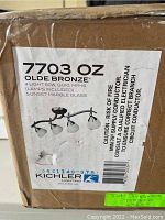 Box label showing model 7703 OZ Olde Bronze 4-light fixture, 50W GU10 MR16 with sunset marble glass