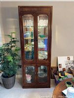 Full front view of the Thomasville china hutch cabinet closed with contents inside