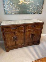 Front view of sideboard with two drawers above two cabinet doors and runner on top