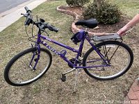 Full side view of purple Univega Rover Sport women's bike showing frame, tires, seat, and rear rack.