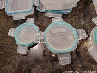 Top view of round Snapware container with snap-lock lid, showing blue silicone sealing ring and locking tabs.