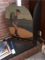 Full view of the curved top dividing screen panel, showing the golfer, bunker, and surrounding golf course setting.