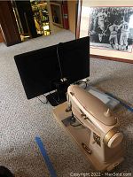 Side view showing sewing machine and HP monitor in setting.