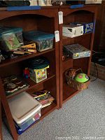 Shelves holding containers of toys, books, puzzles, and a colorful ball in a basket.