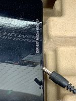 Close-up of router top showing model number DIR-857 MEDIA ROUTER and power jack.