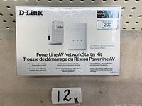 Front and back view of D-Link PowerLine AV Network Starter Kit box showing key features and product images.