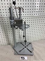 Full view of the metal drill press stand showing base, column, adjusting lever, and platform.