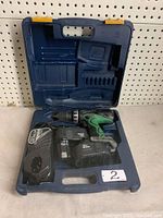 Blue Mastercraft carrying case opened showing the cordless drill and accessories inside arranged in molded compartments.