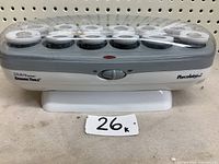 Front view of Jilbere ceramic hot curlers with clear lid and multiple curlers inside