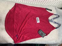 Red Nike Dri-FIT trainer tank top with mesh side panels and white branded straps with 'JUST DO IT' text.