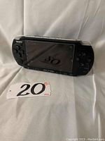 Sony PSP handheld console angled view showing screen and buttons.