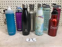 Nine assorted water bottles including specific brands and colors shown