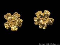 Close-up of flower-shaped 14K gold earrings showing fine petal details.