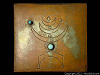 Top-down view of the vintage copper box lid showing abstract esoteric design with turquoise stones and aged patina.