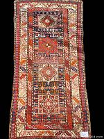 Full front view of rug on black background showing overall pattern and borders