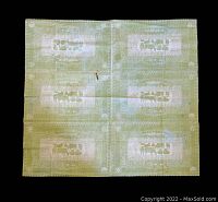 Full view of green and white fabric panel showing six blocks with cow motifs, some discoloration and a rust stain on the top middle area.