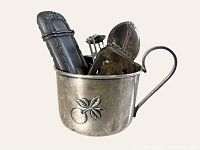 Photo showing all 4 sterling vanity items in the cup for scale: bookmark, cup, lipstick holder, and hairpin holder.
