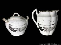 Porcelain sugar bowl and pitcher showing Normans Woe scene with rock and ocean waves in black and white.