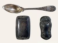 Photo showing the sterling silver New Orleans souvenir spoon with stork motif along with the two ornate antique match safes, one with an engraved monogram.