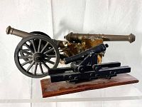 Side view of three desk cannons showing size and construction