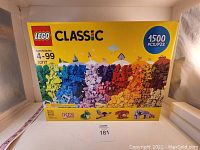 Front view of the unopened LEGO Classic 1500 piece box featuring colorful bricks in a rainbow arrangement.