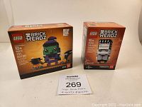 Front view of boxed Lego BrickHeadz 40272 Witch and 40422 Frankenstein sets, showing full box artwork and labels.