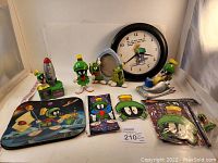 All Marvin the Martian themed items arranged including clock, tape dispenser, figurines, frame, pencil case and flat collectibles.