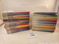 Two stacks of Teddy Ruxpin books with visible colorful spines and titles.