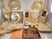 Overall assortment of unfinished wooden Halloween themed craft pieces and signs, some in plastic packaging.