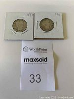 Two Barber Head Silver Quarter Dollar coins dated 1897 and 1911 in white cardboard holders