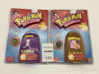 Two factory sealed Pokémon Collector Marble Pouches together, showing full packaging and characters Mew and Clefairy.