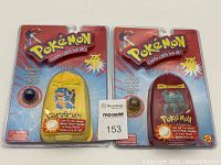 Two sealed Pokémon Collector Marble Pouches in blister packaging, one yellow pouch with Blastoise and one red pouch with Machamp visible through packaging, with included marbles.