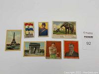 Full view of eight antique tobacco cards showing various images and advertising