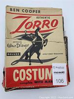 Front view of the Ben Cooper Authentic Zorro Deluxe costume box featuring vintage graphics including Zorro on horseback silhouette, showing crease and tear damage.