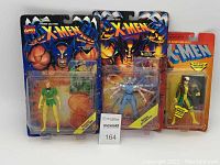 Photo showing the three vintage X-Men action figures in original blister pack packaging, front view with card art visible and figures inside.