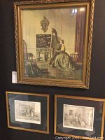 Photo showing the set of three framed artwork prints on a wall, including the large colored harp player and two smaller black and white prints.