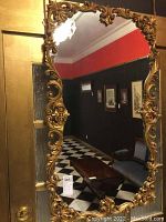 Full frontal view of rectangular mirror with carved giltwood frame