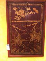 Front view of the painted wooden artwork showing warrior on horseback with spear, floral accents, bird, and decorative border.