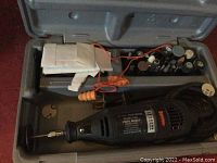 Open case showing Craftsman rotary tool and multiple rotary tool attachments in compartments.