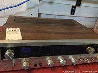 Full front and top view of the Toshiba receiver showing wooden casing and front panel with knobs and switches.