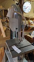 Full front view of Delta band saw with table and stand