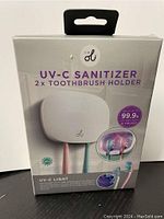 Front view of product packaging showing two UV-C toothbrush holders and branding details.