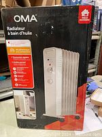 Box of OMA oil filled radiator heater showing front and side features with text in French and English.