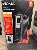Box front showing NOMA Digital Oil-filled Heater, model features, and design.