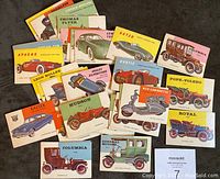 Spread of vintage 1953 Topps World on Wheels car cards showing a variety of different models and artwork including Apache, Leon Bollee, Hudson, Columbia, Royal, Kaiser, Thomas Flyer and others.