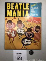 Front cover of the Beatle Mania magazine showing illustrated images of The Beatles as cartoon musicians with guitars, bright yellow and red text, and an announcement of full-color inserts inside.