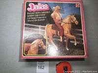 Photo of the original bright pink cardboard box featuring Barbie on a golden palomino horse and text branding.